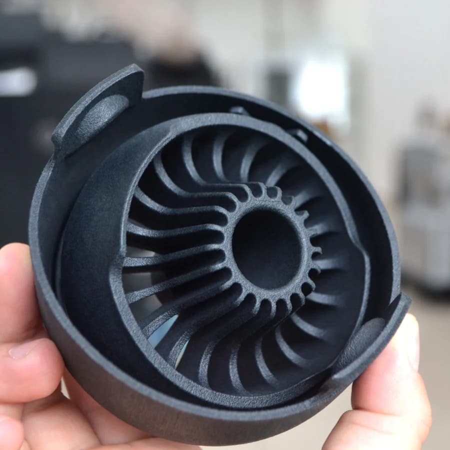 Black dyed PA12 impeller housing held in hand